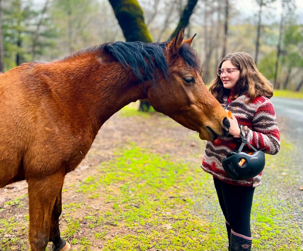 A girl petting a horse